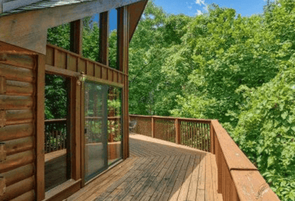 Beautiful log cabin deck overlooking treetops in the Smoky Mountains