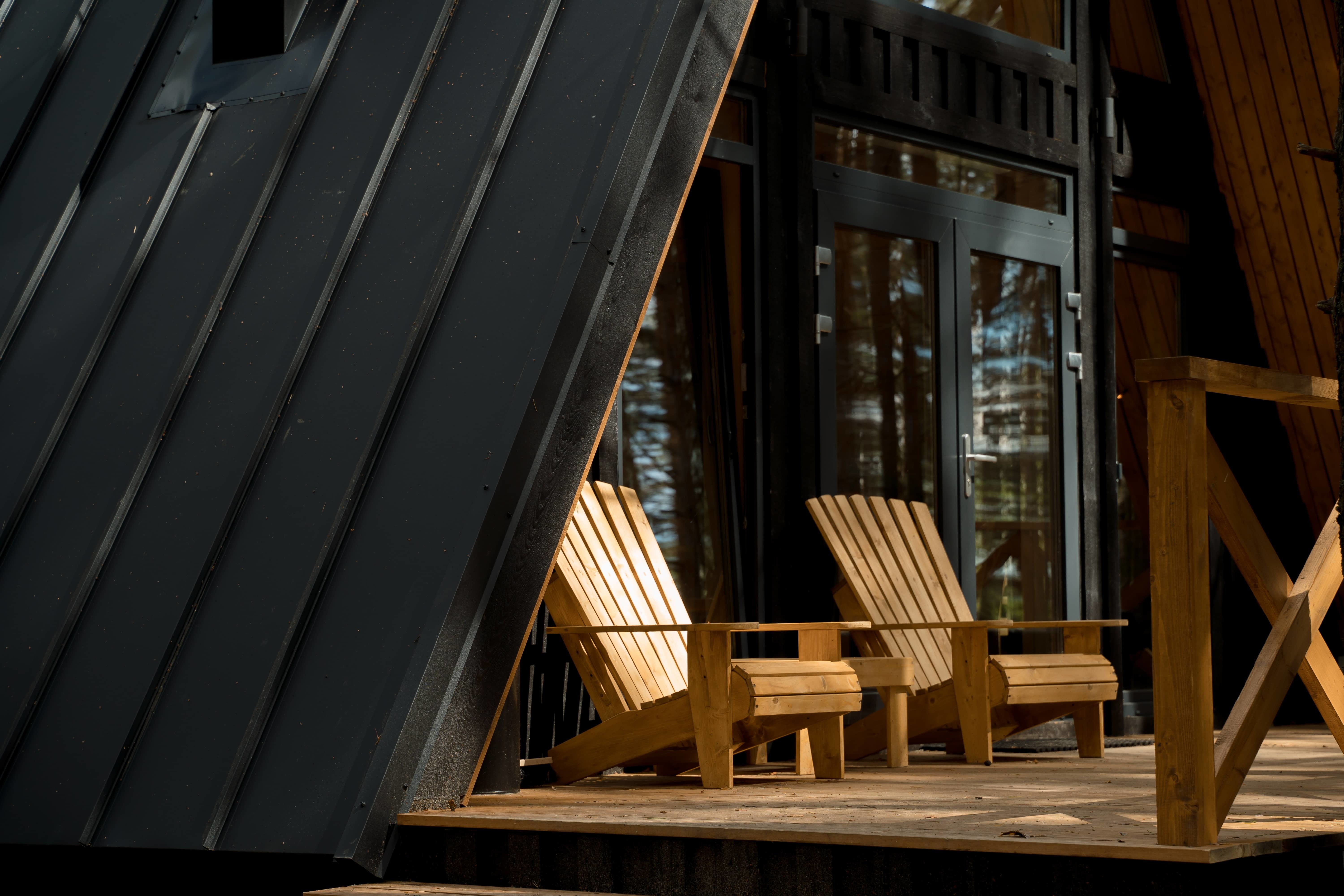 2 Adirondack chairs on a cabin front porch 